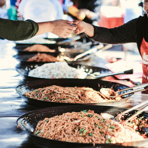Close-up of people preparing food at market