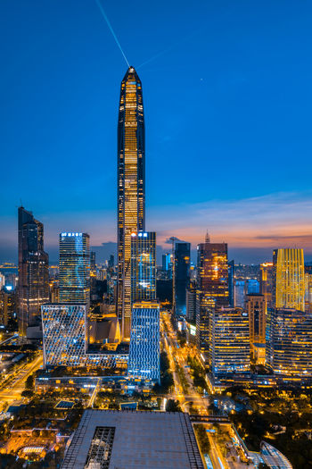 Illuminated buildings against sky at night