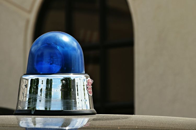Close-up of blue vintage police car siren.