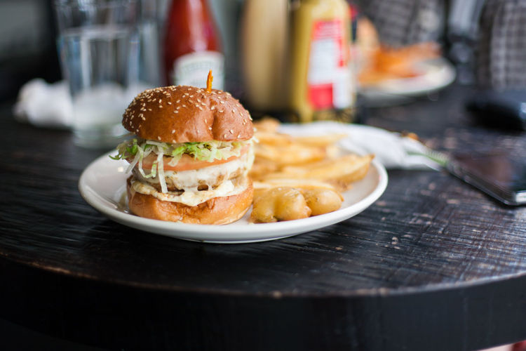 Close-up of chicken burger with french fries on plate