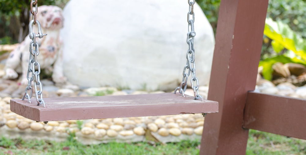 Close-up of swing hanging from fountain