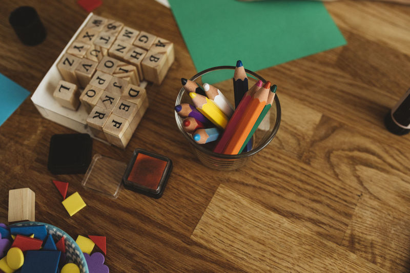 High angle view of crayons and stamps