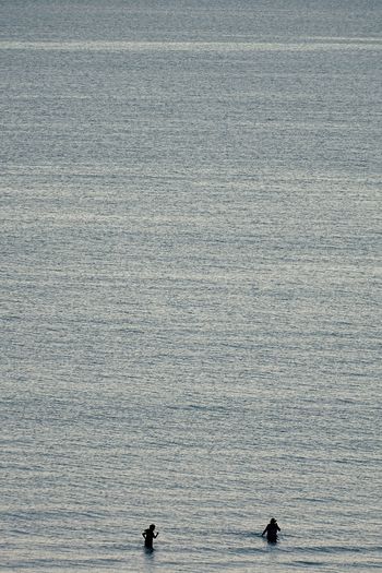 People walking and talking in sea