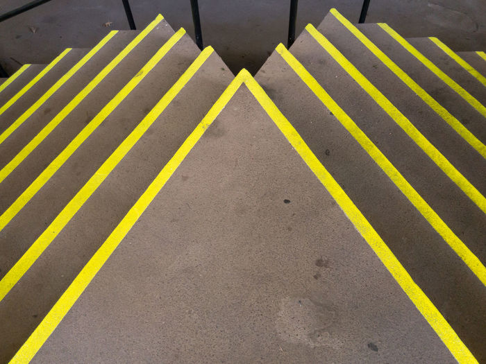 High angle view of yellow stripes on concrete stairs