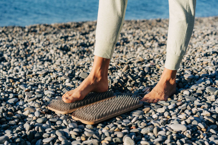Close-up of a foot on a board with nails, spiritual practice of acupuncture and acupressure.