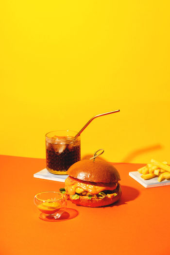 Close-up of drink on table against yellow background