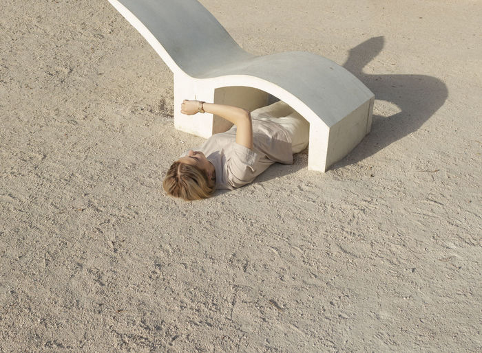 High angle view of person lying on sand