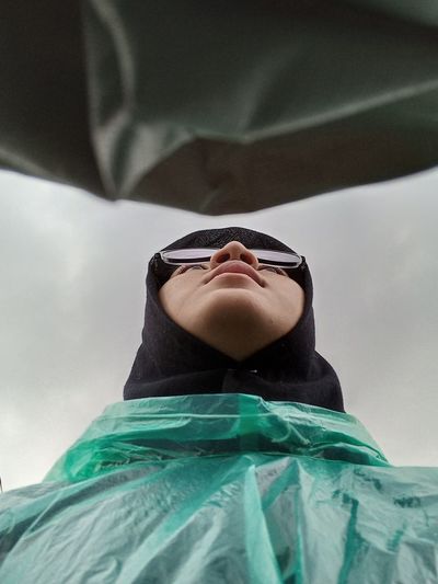 Low angle view of young woman in car