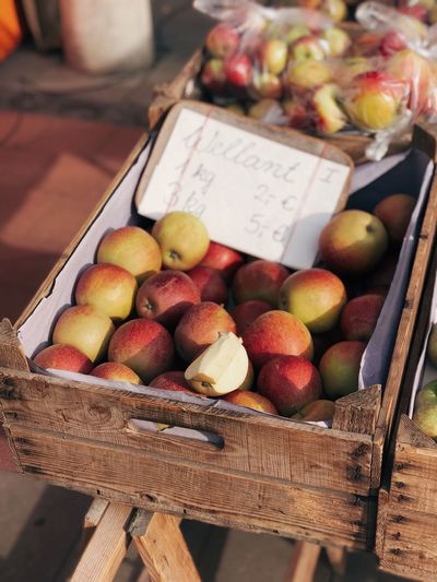High angle view of apples in basket for sale at market stall