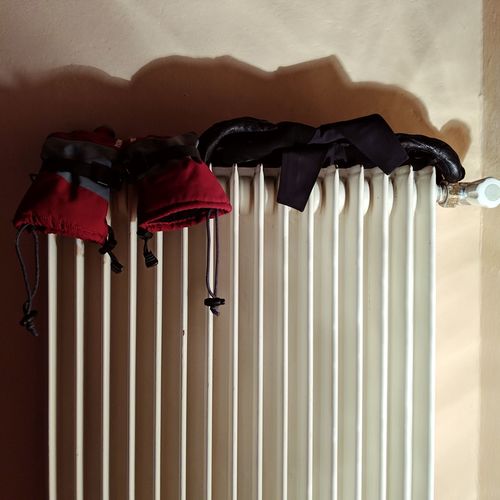 Close-up of clothes drying against white wall