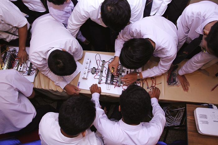 High angle view of students working in classroom