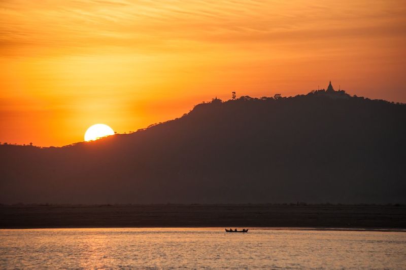 Scenic view of sea against orange sky
