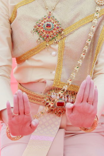 Midsection of woman wearing traditional clothing during songkran