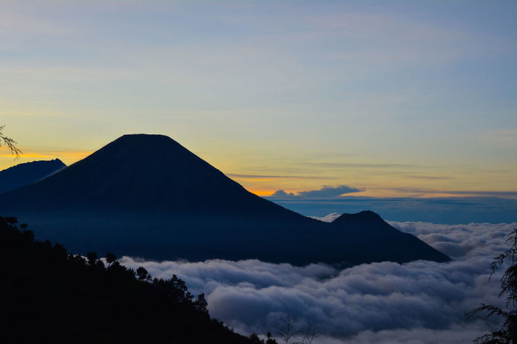 Scenic view of silhouette mountains against sky during sunset