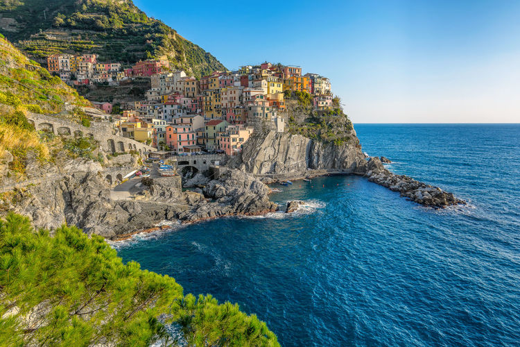 Scenic view of the small village of manarola, cinque terre against the blue mediterranean sea