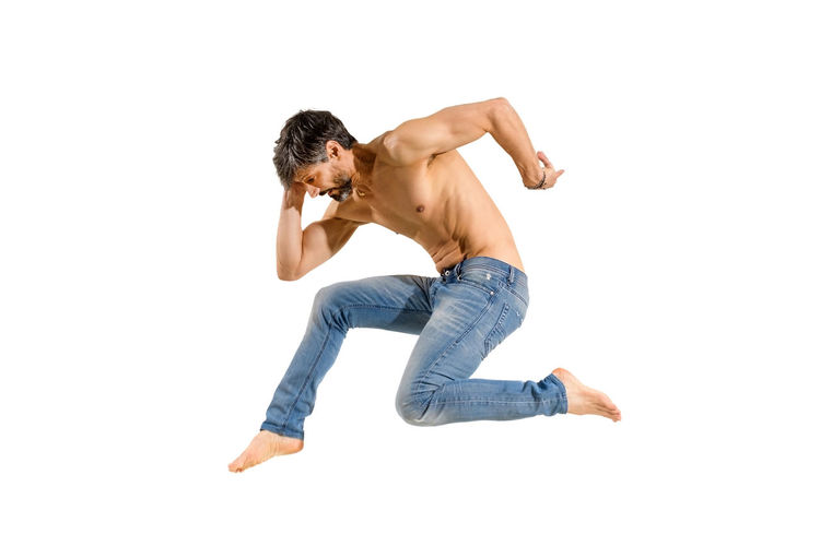 Side view of shirtless man against white background