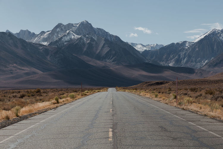Road amidst mountains against sky