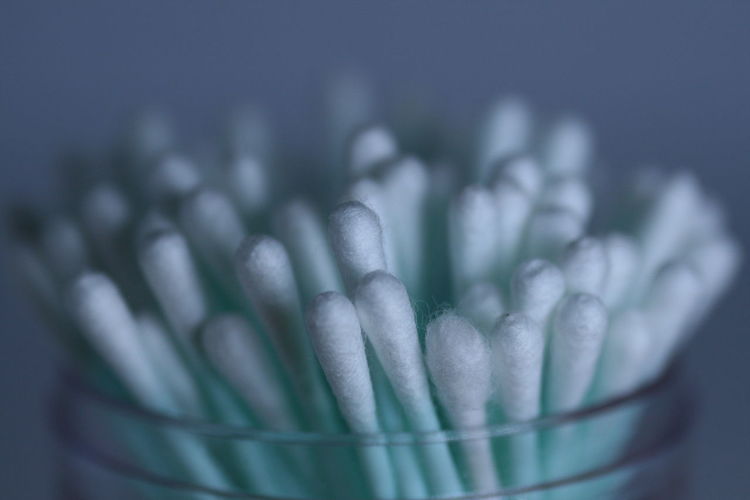 Close-up of cotton swabs in jar