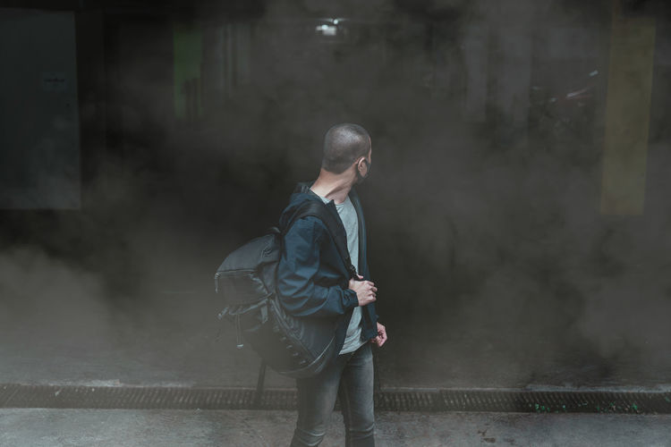 Man with backpack standing on road