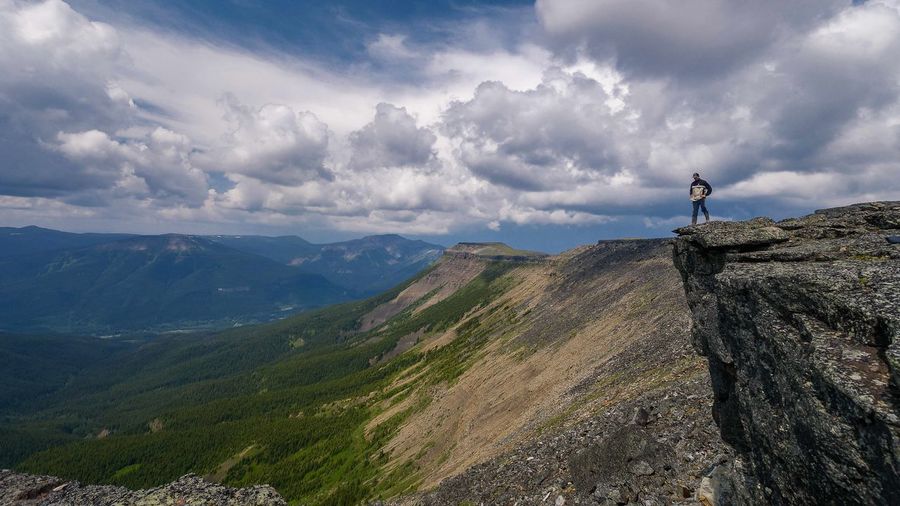 Man standing on mountain against sky