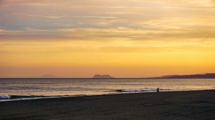 Scenic view of sea against orange sky