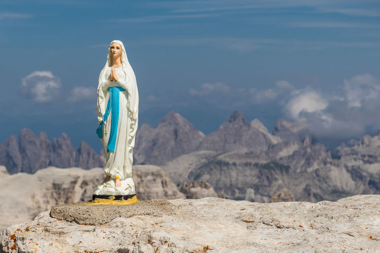 Virgin mary on rock against piz boe
