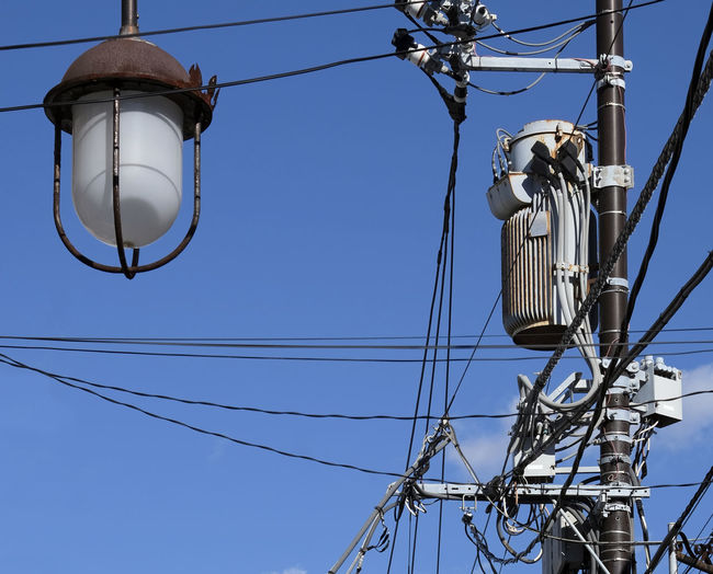Low angle view of electricity pylon against clear sky