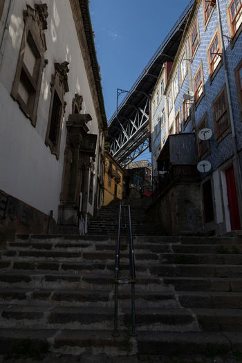 Low angle view of staircase amidst buildings in city