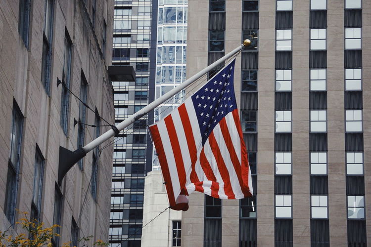 Close-up of flag against buildings in city