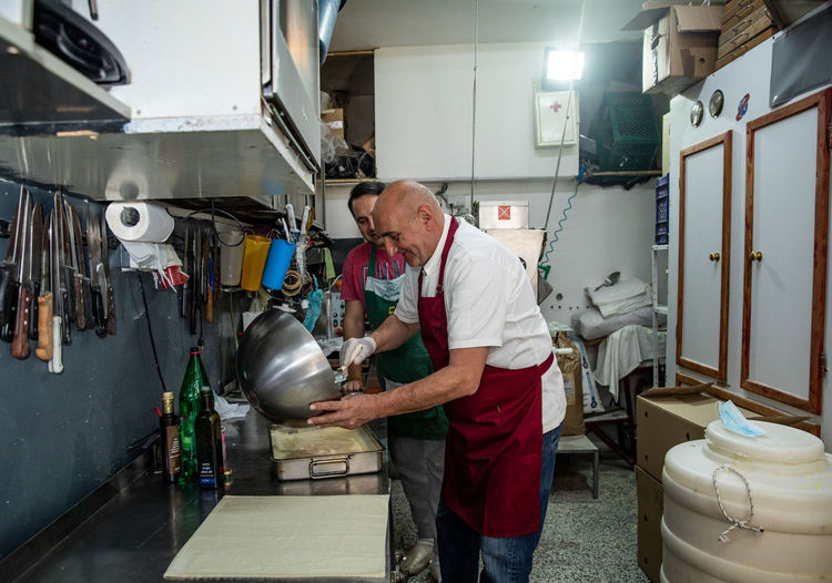 Father and son making traditional balkan gibanica in belgrade, serbia