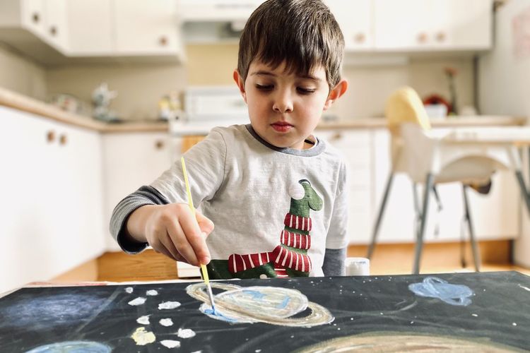 Boy making crafts at home