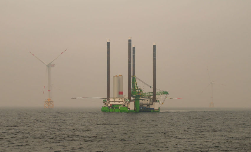 Wind farm offshore energy wind turbine construction on the north sea