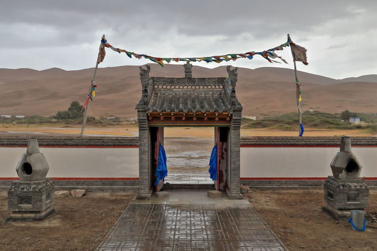 1116 buddhist prayer flags lung ta-e..facing arch-badain jaran desert temple. inner mongolia-china.
