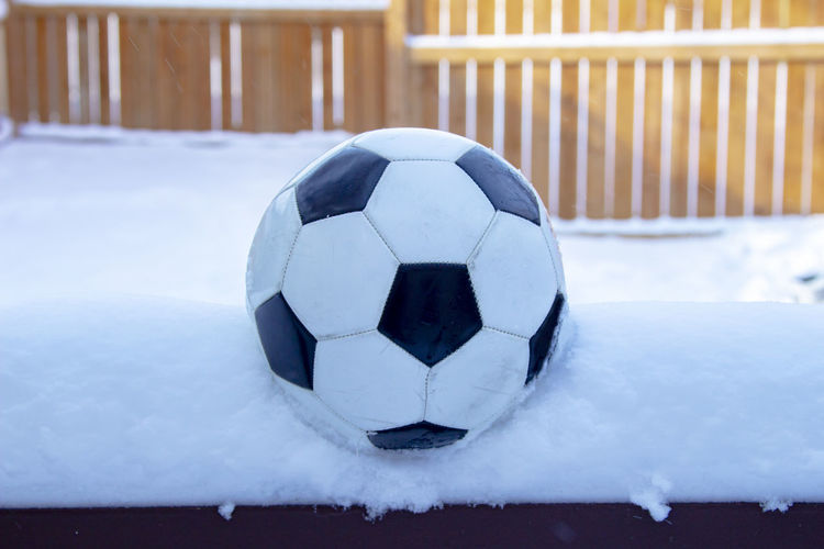 Close-up of ball on snow covered field