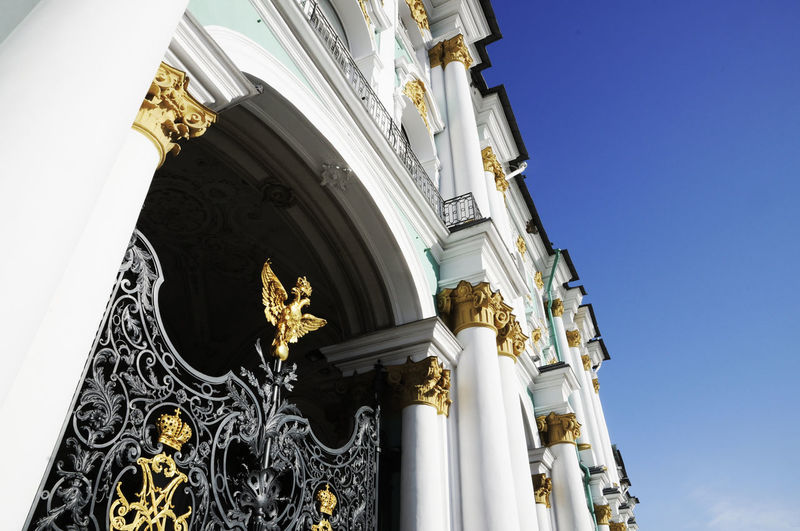 Low angle view of winter palace against clear blue sky