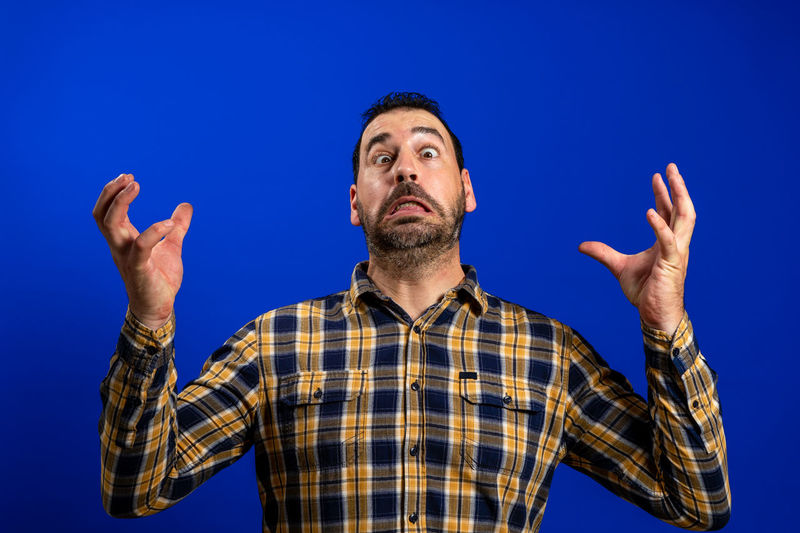 Low angle view of man against blue background