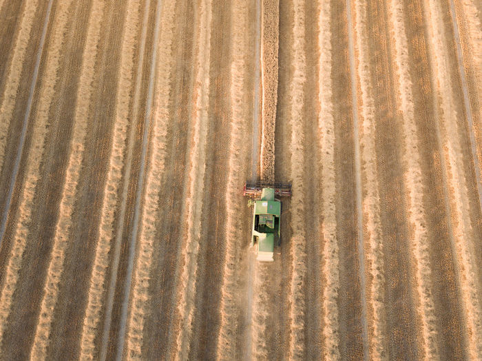 Aerial view of combine harvester on agriculture landscape