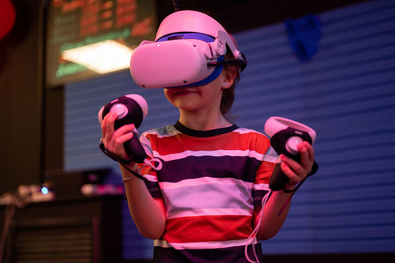 Vr game and virtual reality. kid boy gamer six years old fun playing on futuristic video game