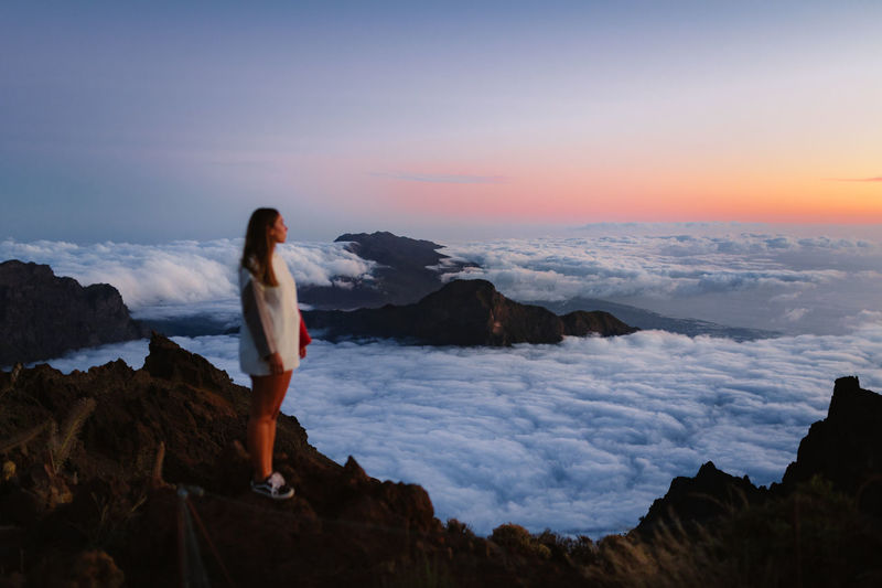 Youn girl looking the amazing landscape at sunset