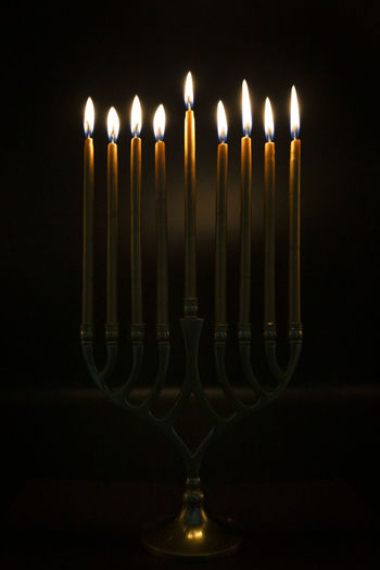 Gold candles lit in hanukah menorah