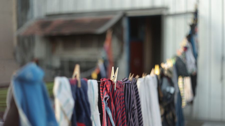 Close-up of clothes hanging on built structure