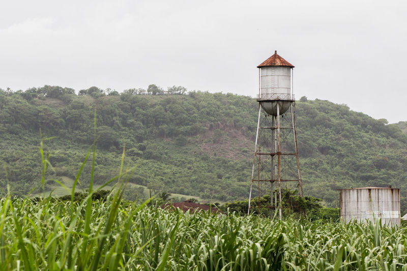 Scenic view of water tower on land against sky