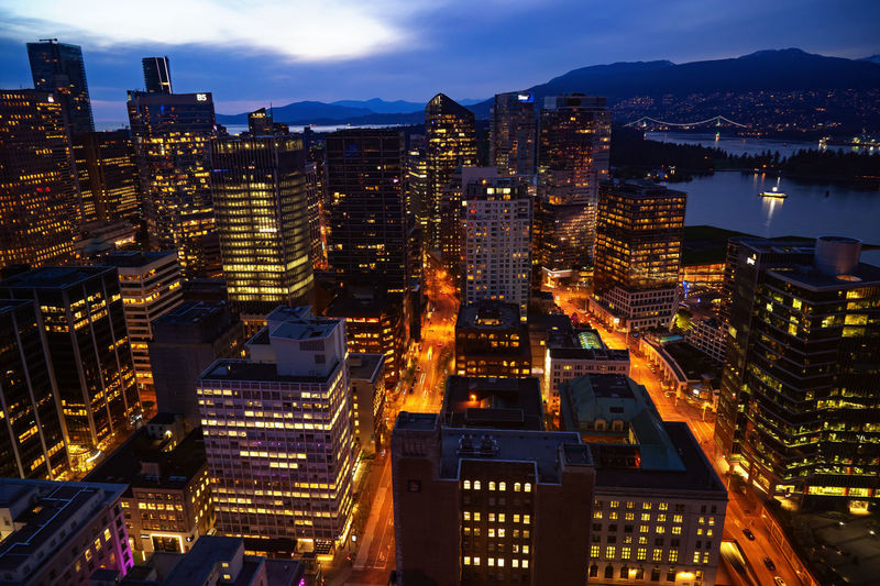 Aerial view of illuminated city buildings at night