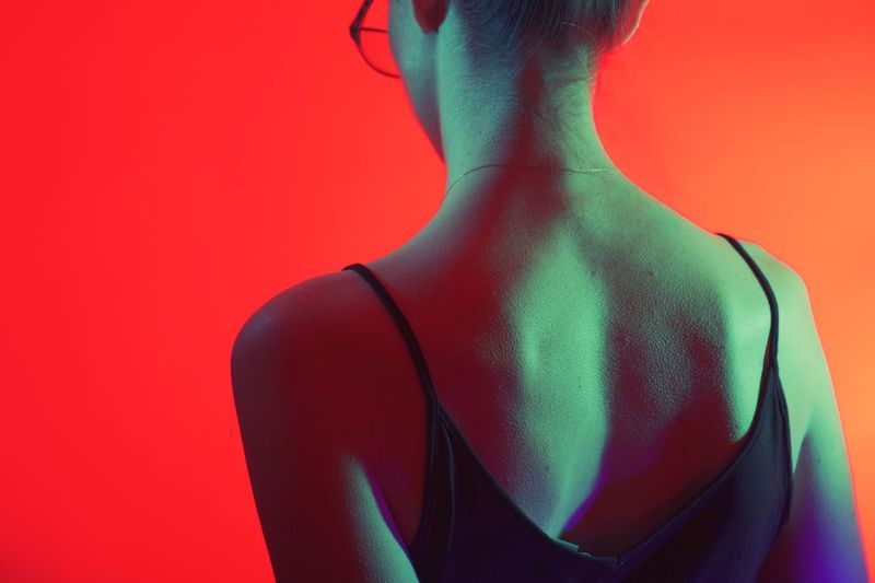 Rear view of woman against red background