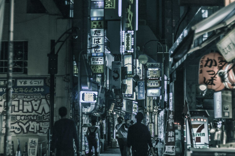 People walking in city at night