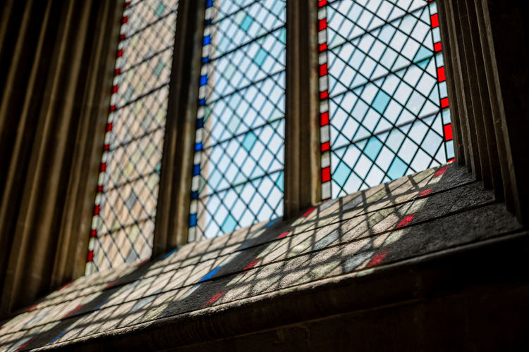Low angle view of stained glass window in church