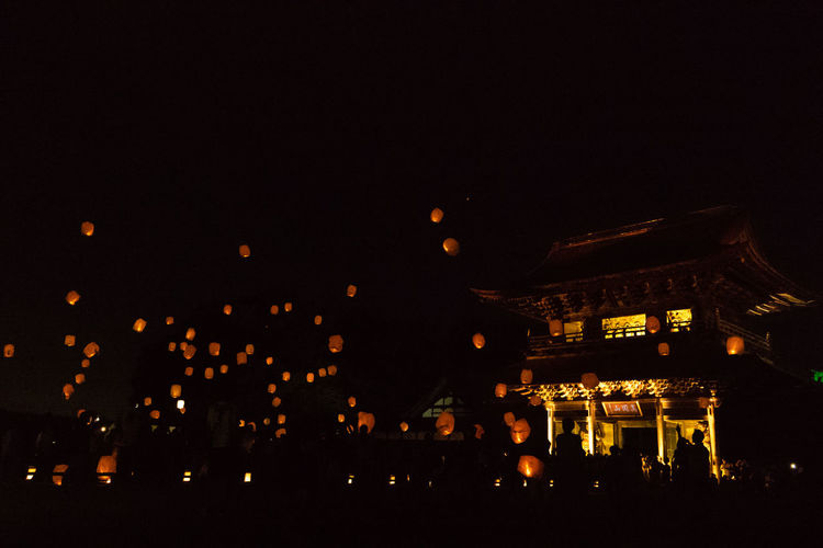 Illuminated city buildings at night