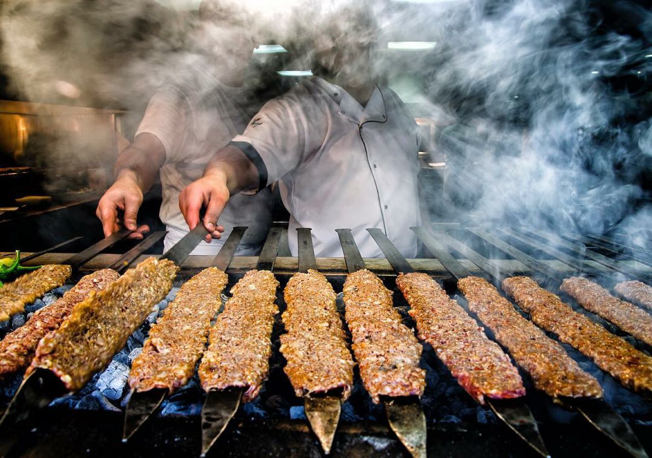 Man preparing food on barbecue grill