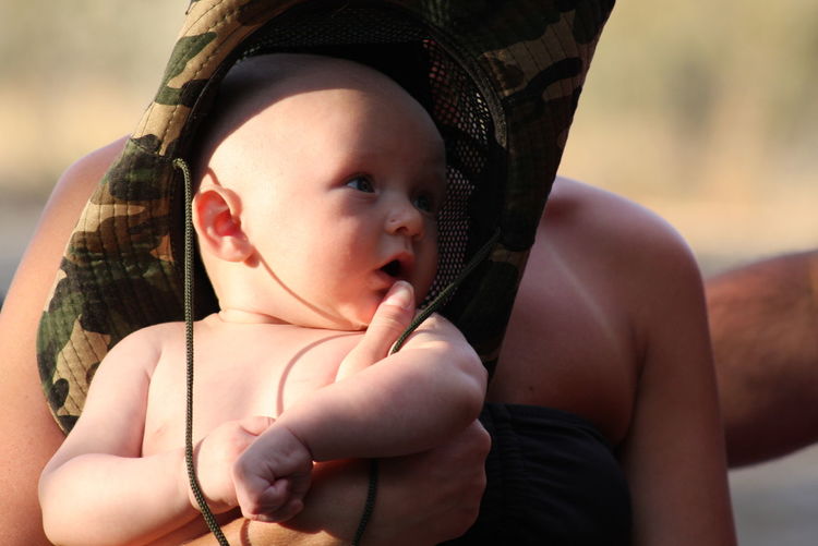 Motehr and baby sitting outdoors