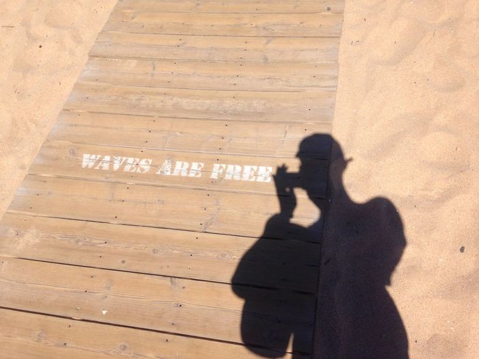 Shadow of people on footpath